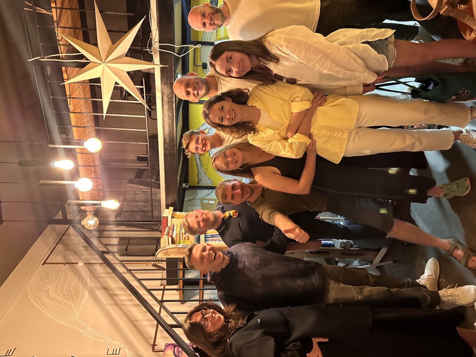 A group of guests smiling together under warm lights